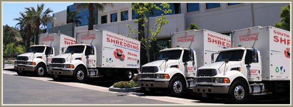 Five Southern California Shredding trucks parked in a row
